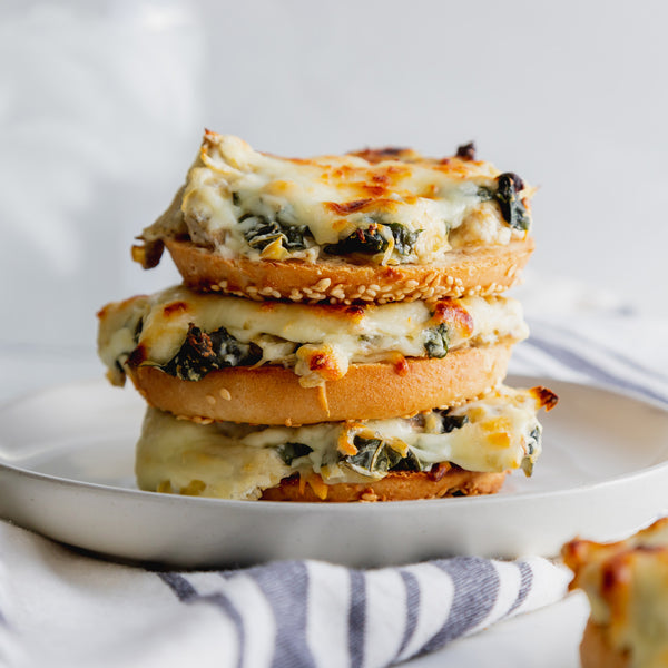 Toasted Spinach & Artichoke Pagel Melts - Bedrock Bakers
